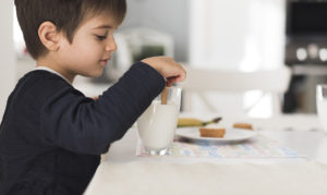 https://www.freepik.com/free-photo/front-view-kid-dipping-biscuit-milk_6877801.htm