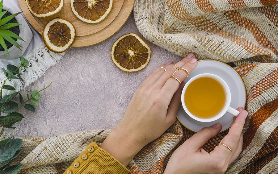 https://www.freepik.com/free-photo/overhead-view-woman-s-hand-holding-herbal-tea-cup-dried-lemon-textured-backdrop_4497027.htm